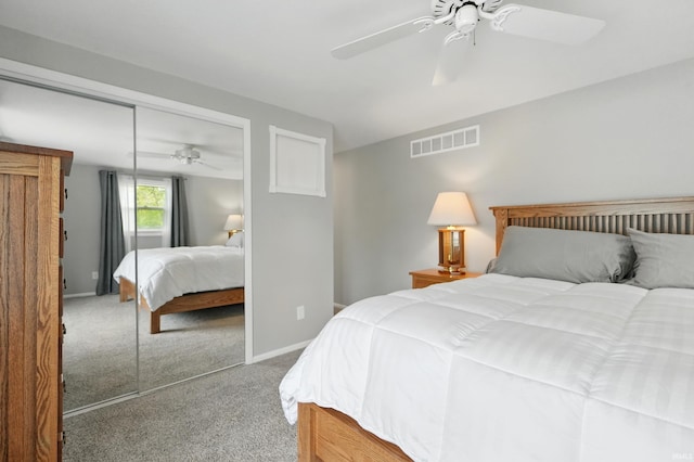 bedroom with carpet floors, a closet, ceiling fan, and baseboards