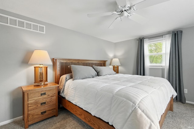 bedroom with light colored carpet, baseboards, and ceiling fan
