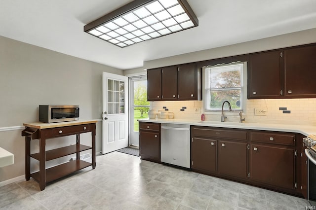 kitchen featuring a sink, appliances with stainless steel finishes, tasteful backsplash, and light countertops
