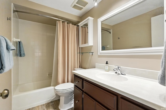 bathroom with toilet, vanity, and shower / bath combo with shower curtain