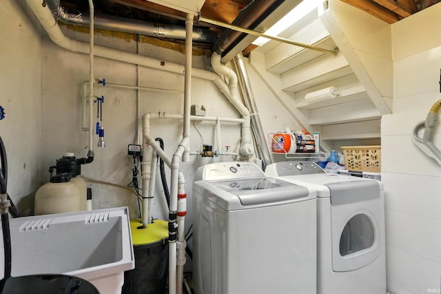 clothes washing area with washing machine and dryer