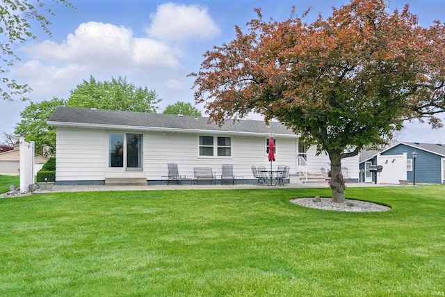 rear view of property with a patio and a yard