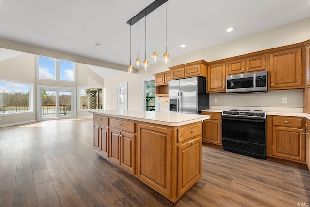 5006 Vandolah Rd, Leo, IN 46765 - kitchen with appliances with stainless steel finishes, brown cabinetry, a kitchen island, dark wood finished floors, and recessed lighting