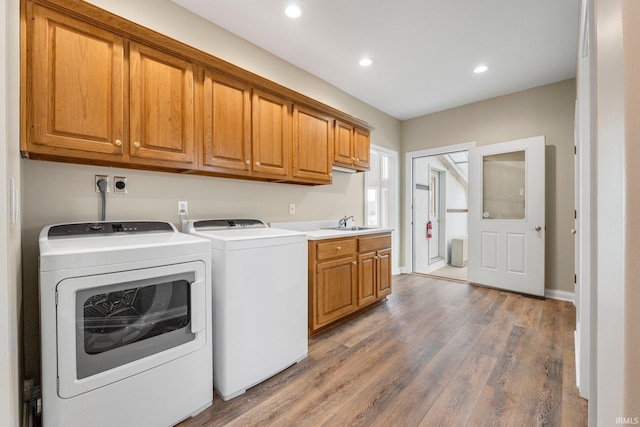 5006 Vandolah Rd, Leo, IN 46765 - clothes washing area featuring washer and dryer, cabinet space, wood finished floors, and recessed lighting