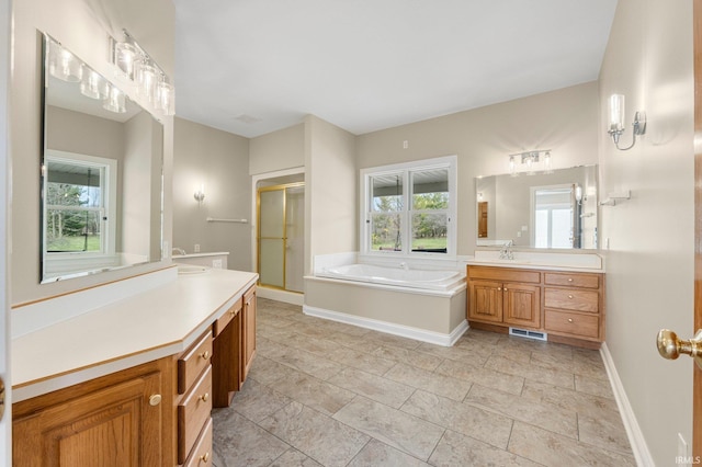 5006 Vandolah Rd, Leo, IN 46765 - full bathroom featuring a shower stall, a garden tub, vanity, and baseboards