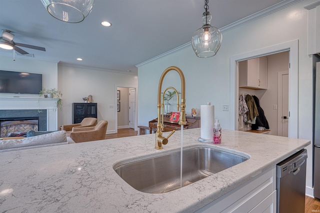 6055 Logel Rd, Newburgh, IN 47630 - kitchen with a sink, stainless steel dishwasher, crown molding, open floor plan, and light stone countertops