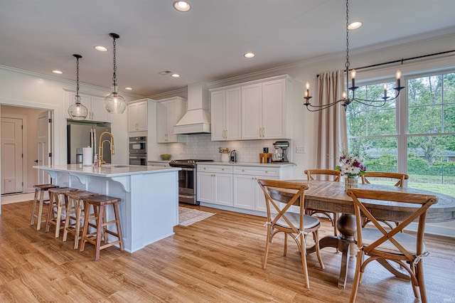 6055 Logel Rd, Newburgh, IN 47630 - kitchen with stainless steel appliances, premium range hood, ornamental molding, light countertops, and tasteful backsplash