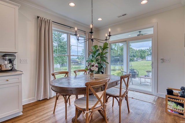 6055 Logel Rd, Newburgh, IN 47630 - dining area with recessed lighting, light wood finished floors, a chandelier, crown molding, and baseboards