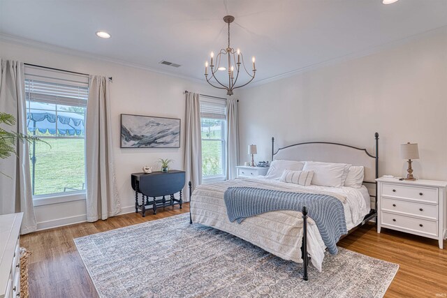 6055 Logel Rd, Newburgh, IN 47630 - bedroom featuring multiple windows, a chandelier, wood finished floors, crown molding, and baseboards
