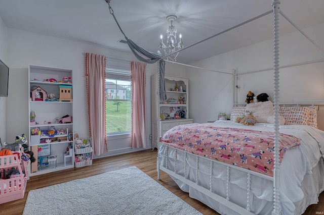 6055 Logel Rd, Newburgh, IN 47630 - bedroom featuring a chandelier and wood finished floors
