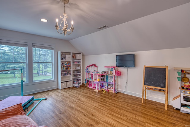 6055 Logel Rd, Newburgh, IN 47630 - recreation room with a chandelier, baseboards, wood finished floors, and vaulted ceiling