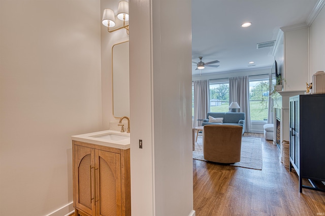 6055 Logel Rd, Newburgh, IN 47630 - bathroom featuring wood finished floors, ceiling fan, a fireplace, vanity, and recessed lighting