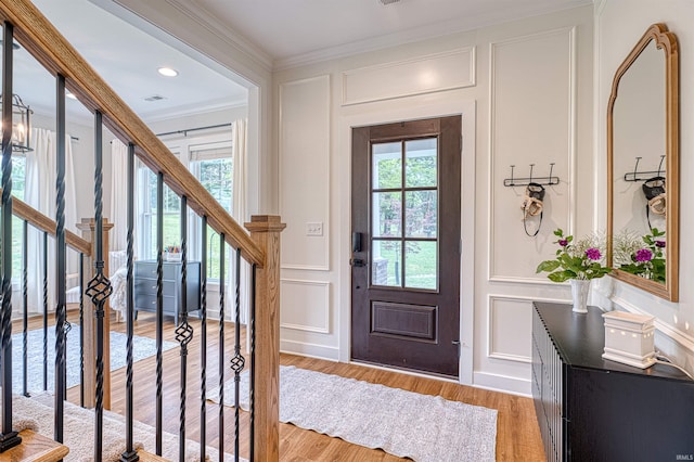 6055 Logel Rd, Newburgh, IN 47630 - foyer entrance featuring a decorative wall, crown molding, wood finished floors, and stairs