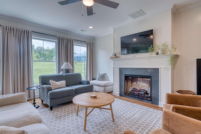 6055 Logel Rd, Newburgh, IN 47630 - living area featuring light wood-style floors, ceiling fan, a premium fireplace, ornamental molding, and recessed lighting