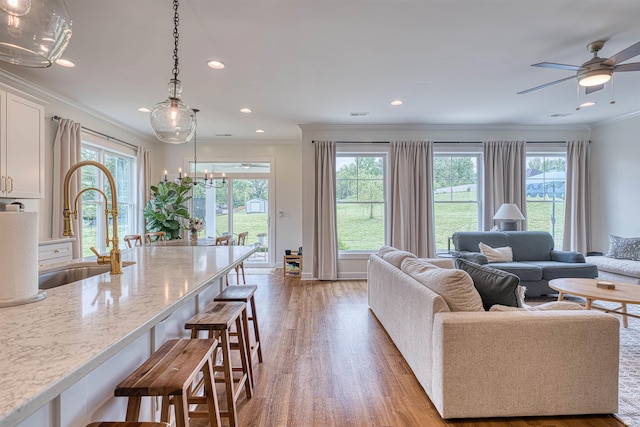 6055 Logel Rd, Newburgh, IN 47630 - living room with light wood-style floors, ornamental molding, a ceiling fan, and recessed lighting