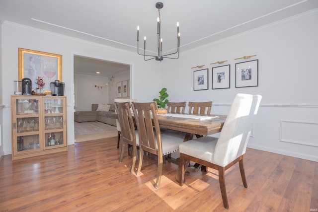 4100 Triple Crown Dr, Newburgh, IN 47630 - dining space featuring a chandelier, ornamental molding, and wood finished floors