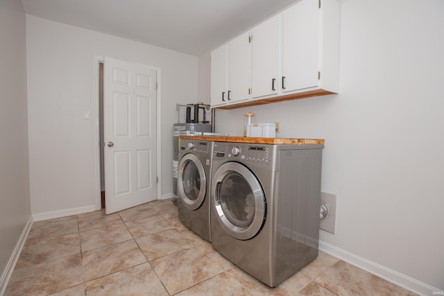 4100 Triple Crown Dr, Newburgh, IN 47630 - washroom with cabinet space, washing machine and clothes dryer, baseboards, and light tile patterned flooring