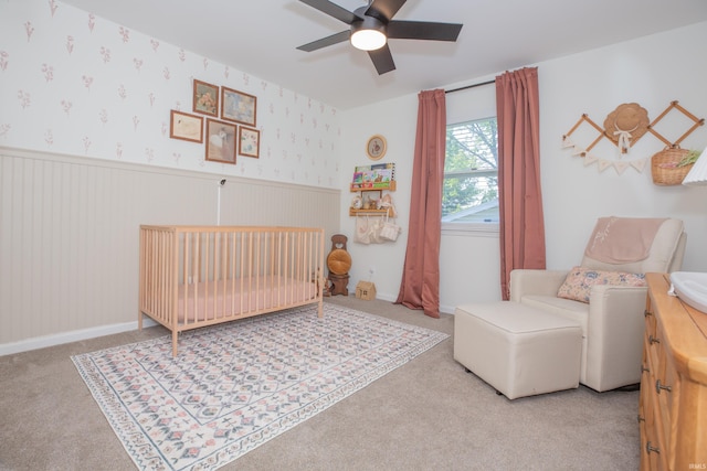 4100 Triple Crown Dr, Newburgh, IN 47630 - bedroom with a crib, a wainscoted wall, carpet, and a ceiling fan