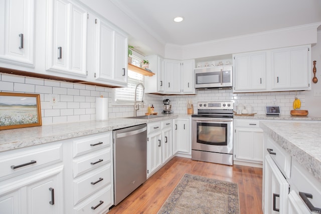 4100 Triple Crown Dr, Newburgh, IN 47630 - kitchen featuring stainless steel appliances, a sink, white cabinets, ornamental molding, and recessed lighting