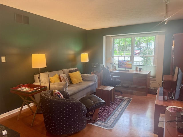 living area featuring an office area and wood finished floors