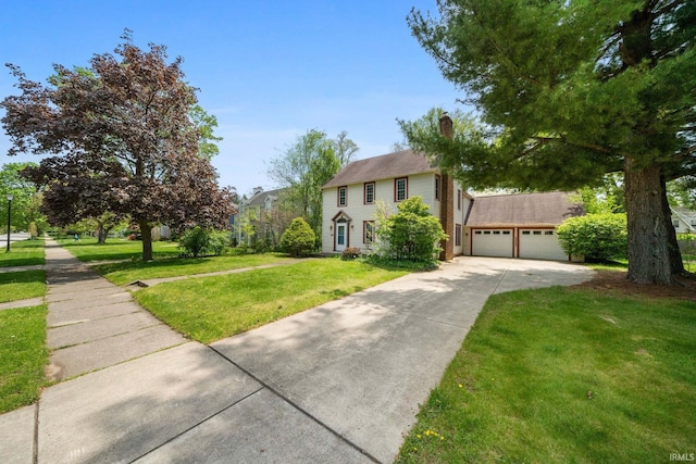 1602 Cedar St, South Bend, IN 46617 - colonial house with concrete driveway, a front lawn, a garage, and a chimney