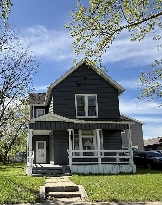 view of front facade featuring covered porch and a front lawn