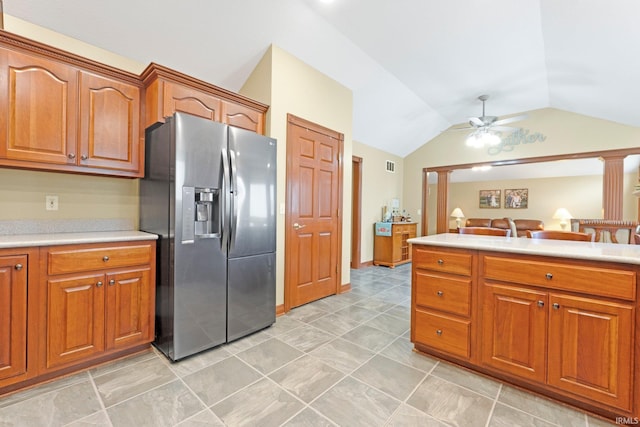 kitchen with stainless steel fridge, lofted ceiling, a ceiling fan, light countertops, and brown cabinetry