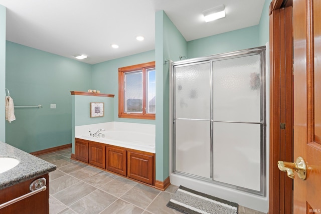 full bath featuring a bath, a shower stall, baseboards, and vanity