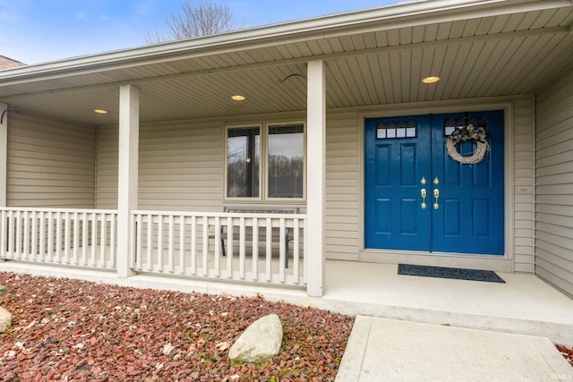 view of exterior entry with covered porch
