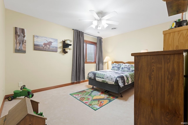 bedroom with carpet floors, ceiling fan, and baseboards