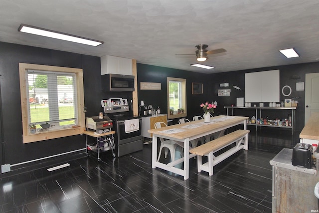 1804 W 11th St, Marion, IN 46953 - dining area featuring a ceiling fan and baseboards