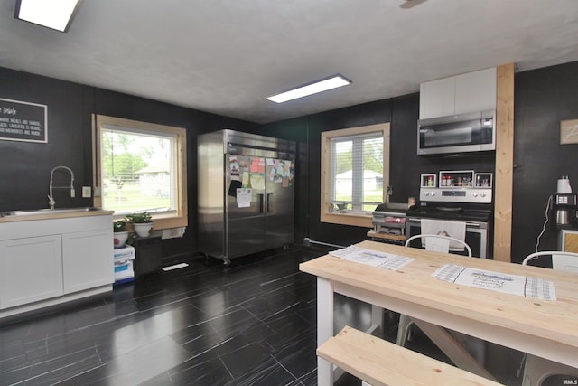 1804 W 11th St, Marion, IN 46953 - kitchen with stainless steel appliances, white cabinets, and a sink