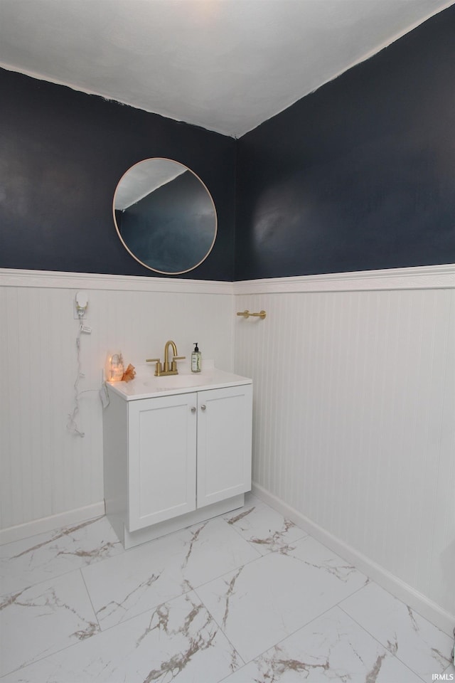 1804 W 11th St, Marion, IN 46953 - bathroom featuring a wainscoted wall, baseboards, marble look tile flooring, and vanity