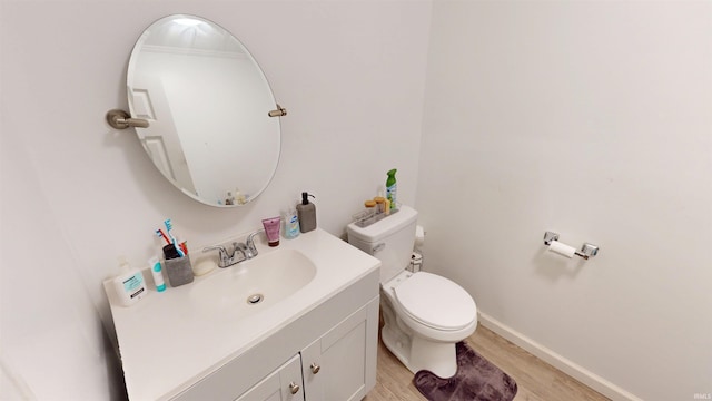 1804 W 11th St, Marion, IN 46953 - half bath with toilet, wood finished floors, vanity, and baseboards