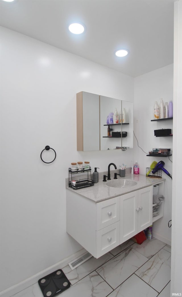 1804 W 11th St, Marion, IN 46953 - bathroom with baseboards, vanity, recessed lighting, and marble look tile flooring