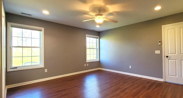 empty room with plenty of natural light, ceiling fan, dark wood-style flooring, baseboards, and recessed lighting