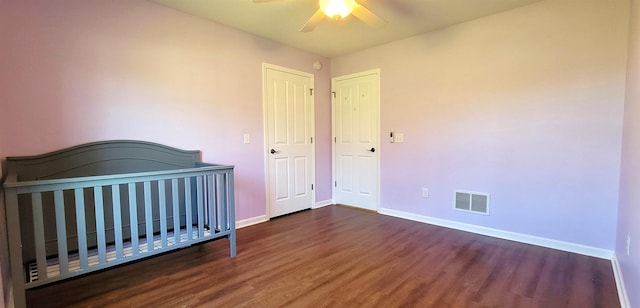 unfurnished bedroom with wood finished floors, baseboards, and ceiling fan