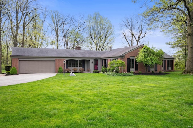 single story home with brick siding, a garage, concrete driveway, and a front yard