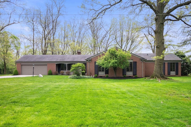 ranch-style home with brick siding, an attached garage, a chimney, and a front lawn