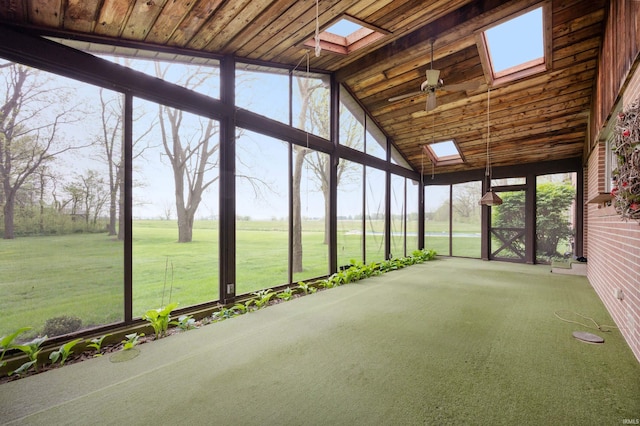 unfurnished sunroom featuring a skylight, vaulted ceiling, and ceiling fan