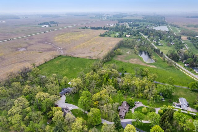 aerial view of property and surrounding area with a large body of water and rural landscape