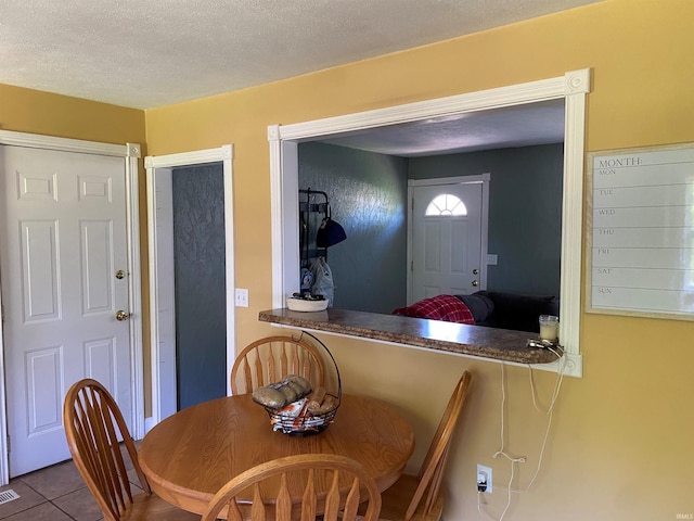 2800 E Bernice Dr, Bloomington, IN 47401 - dining space featuring tile patterned flooring and a textured ceiling