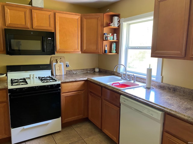 2800 E Bernice Dr, Bloomington, IN 47401 - kitchen featuring black microwave, range with gas cooktop, white dishwasher, a sink, and light tile patterned floors
