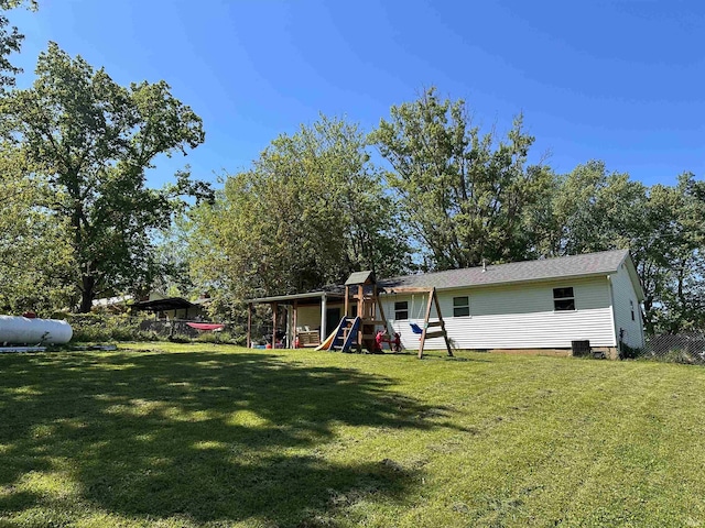 2800 E Bernice Dr, Bloomington, IN 47401 - rear view of house featuring a playground, a yard, and crawl space