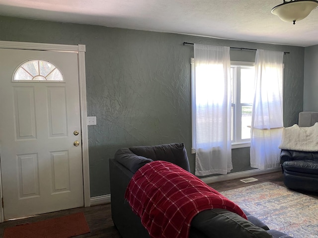 2800 E Bernice Dr, Bloomington, IN 47401 - living room featuring dark wood finished floors, healthy amount of natural light, a textured wall, and baseboards