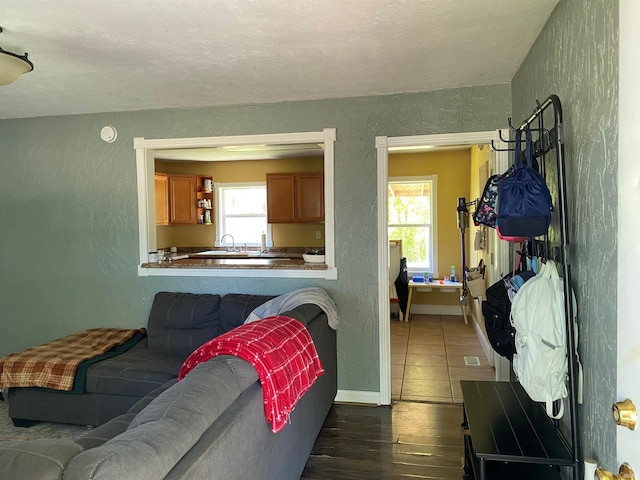 2800 E Bernice Dr, Bloomington, IN 47401 - living area with dark wood-style floors, a textured wall, and baseboards