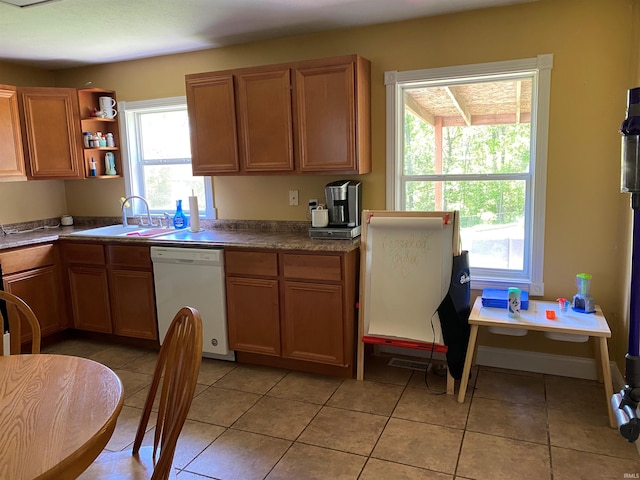 2800 E Bernice Dr, Bloomington, IN 47401 - kitchen with white dishwasher, a sink, open shelves, light tile patterned flooring, and dark countertops