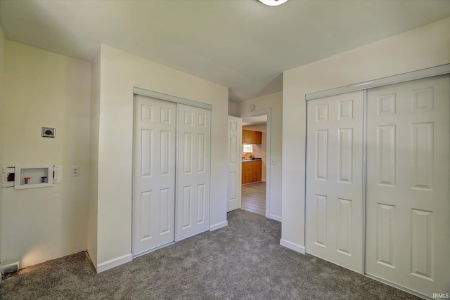 4184 Walker Ln, Unionville, IN 47468 - unfurnished bedroom with dark colored carpet, baseboards, and multiple closets