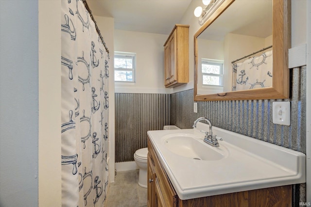 4184 Walker Ln, Unionville, IN 47468 - bathroom featuring toilet, vanity, a wainscoted wall, and tile patterned flooring