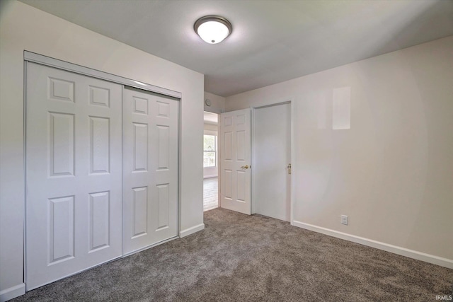 4184 Walker Ln, Unionville, IN 47468 - unfurnished bedroom featuring dark colored carpet, baseboards, and a closet
